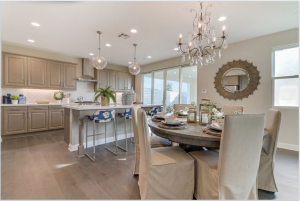 The open floorplan of Sespe's Plan 3 creates easy flow between the island kitchen and living and dining areas in this gorgeous Ventura new home.